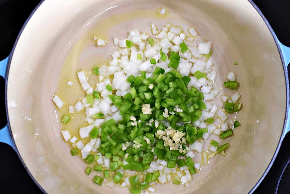 Diced onion, green pepper, and garlic in a dutch oven with olive oil.