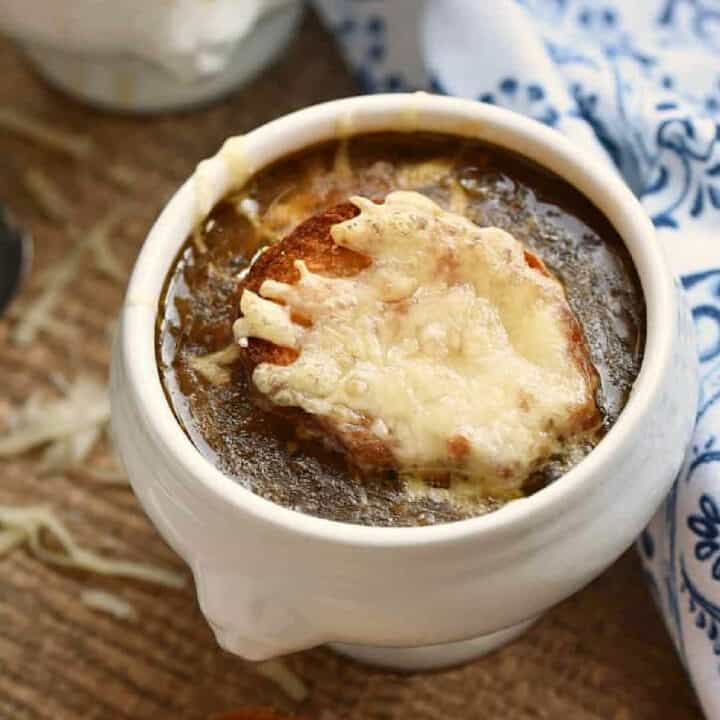 Instant Pot French Onion Soup topped with melted cheese bread.