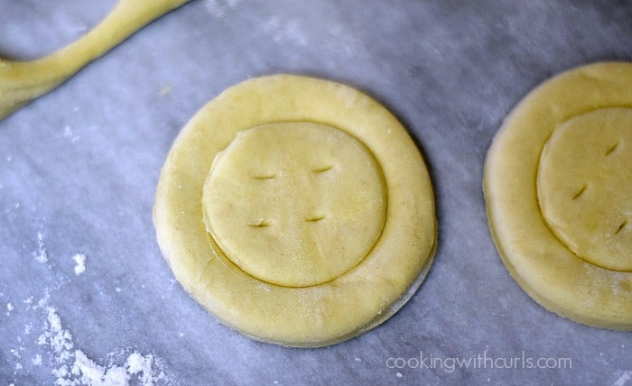 Vent holes pricked into the center of the puff pastry circles.