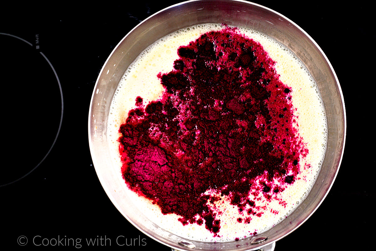 Milk, cream and dragon fruit powder in a saucepan. 