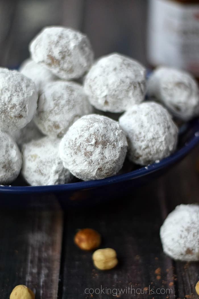 A pile of Nocciolata Teacakes in a dark blue bowl