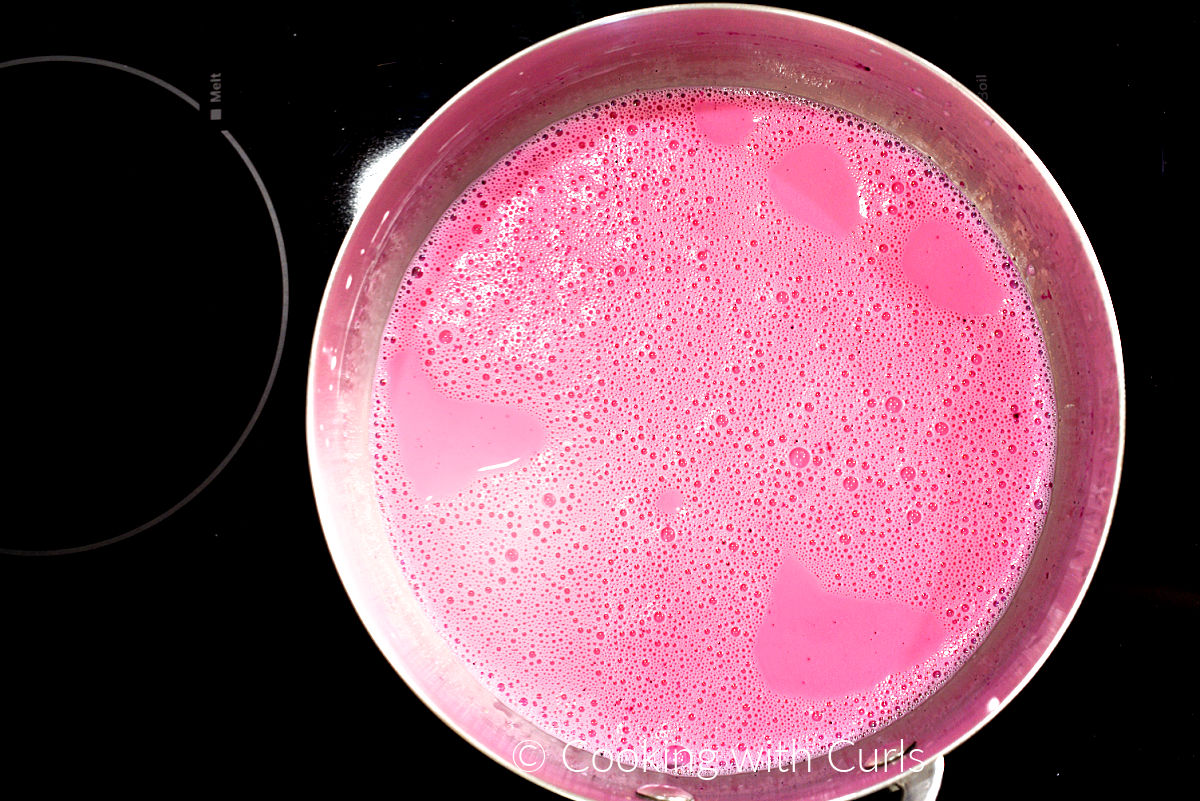 Pink panna cotta mixture in a saucepan. 