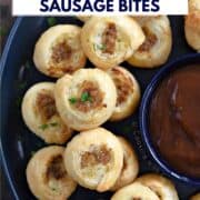 Looking down on a stack of puff pastry sausage bites on a large plate with a bowl of dipping sauce in the center and title graphic across the top.